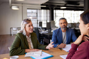SBA resource partners discussing business strategies with an entrepreneur in an office setting.